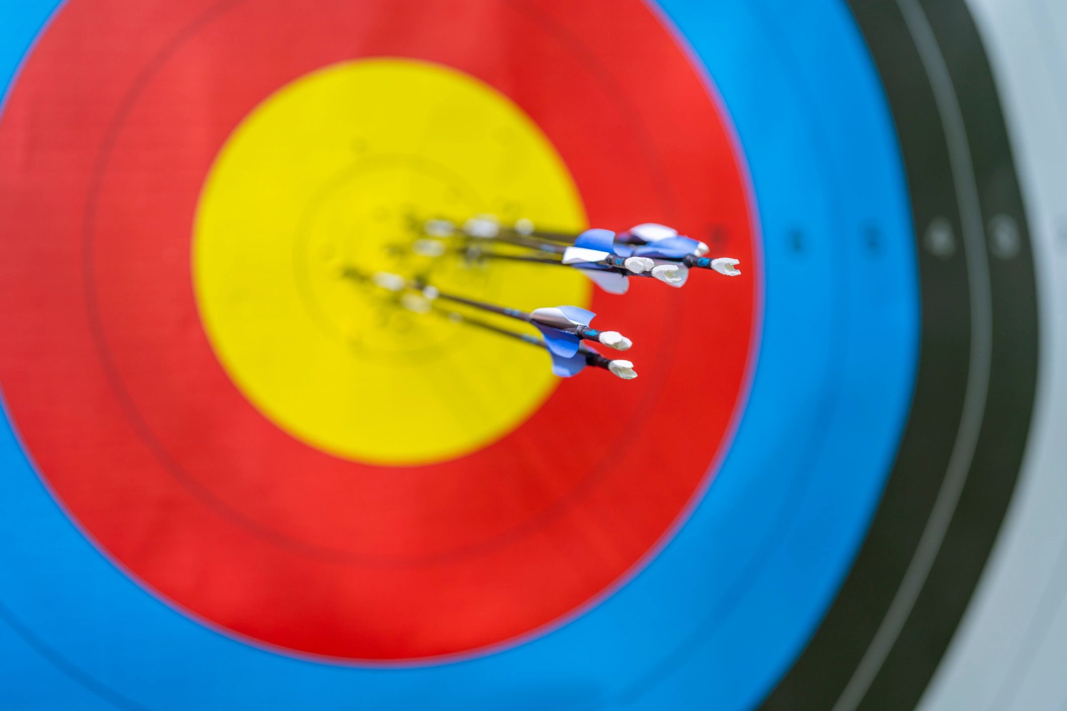 Archery target with arrows grouped near the bullseye